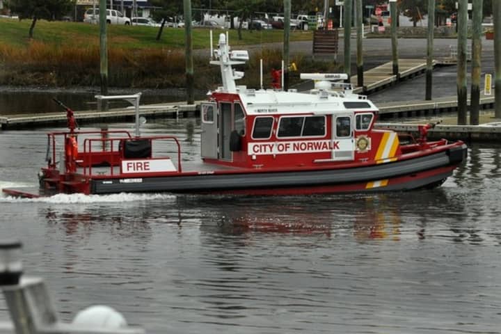 The Norwalk Fire Department Marine Unit rescued four men who were clinging to the side of a capsized vessel.