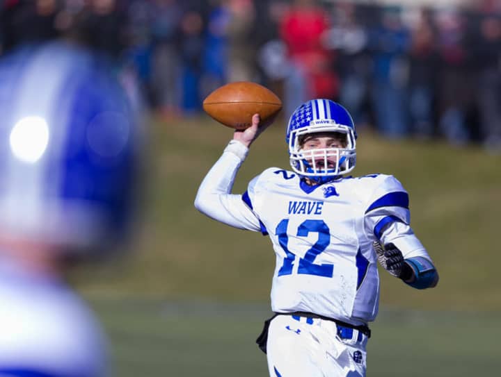 Darien quarterback Silas Wyper throws to a receiver during the Blue Wave&#x27;s win over New Canaan on Thanksgiving. 