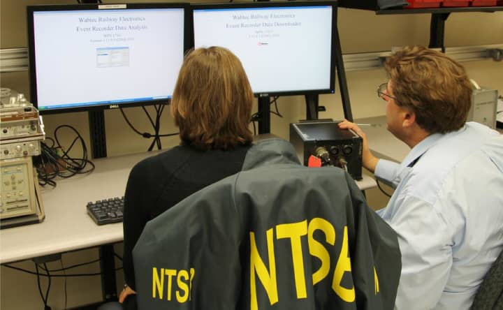 Investigators prepare to download data from the Metro-North locomotive event recorder at the NTSB lab in Washington.