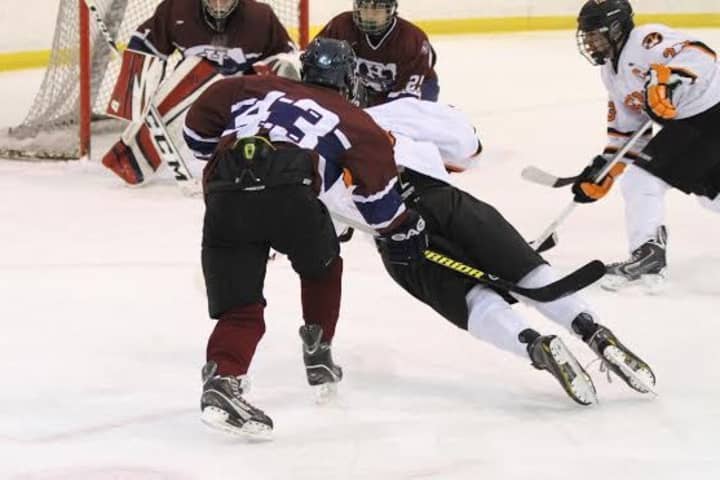 A player on the Harvey School hockey team glides toward the net.