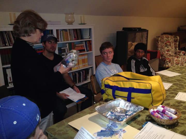 Norma Peterson of the Fairfield Citizen Corps Council teaches St. Timothy&#x27;s High School Group how to assemble emergency kits for the community. L to R : Norma Peterson, Kevin Kelly (Youth Group Leader), Conor Jones, Blake Gottlieb. 