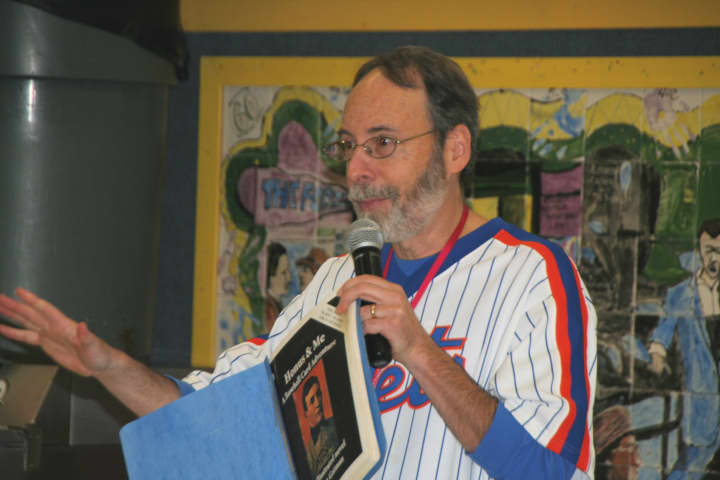Author Dan Gutman shares one of his books with children at Pound Ridge Elementary School.