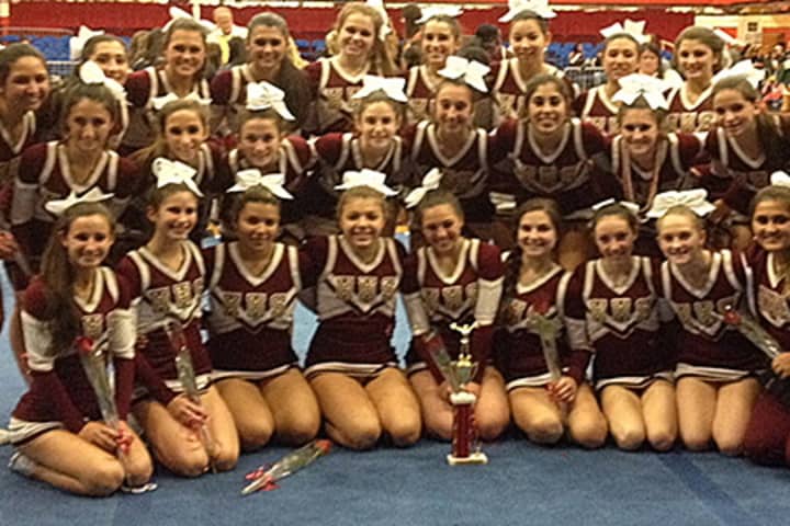 The Harrison varsity cheerleading team celebrates its second-place finish at the Westchester County Center Cheerleading Championships.