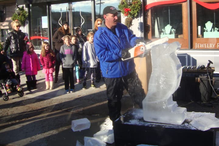 Anthony Tavitian sculpts a penguin from ice at the Holiday Stroll in front of Desires by Mikolay in Chappaqua Saturday.