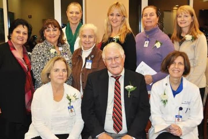 Linda St. Pierre, Joseph Jordan and Dr. Donna Coletti (seated l-r) joined other Home Hospice Program team members at a reception following the Tree of Light ceremony on Monday.
