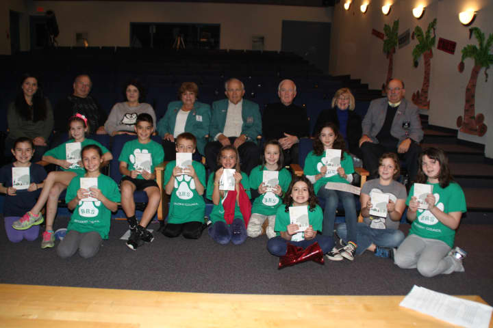 Bedford Road third graders enjoy dictionaries given to them by members of the Elks club.
