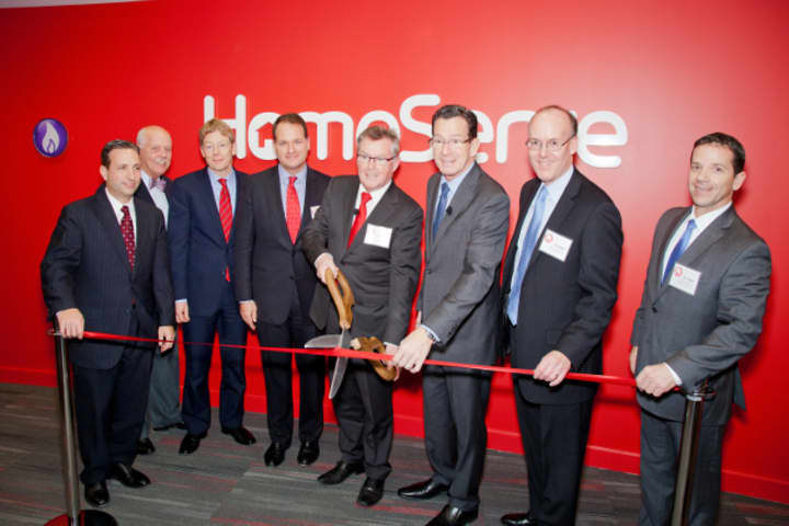 HomeServe Board Chair Barry Gibson and Gov. Dannel Malloy cut the ribbon on HomeServe USA&#x27;s new headquarters in the Merritt 7 Business Park in Norwalk.