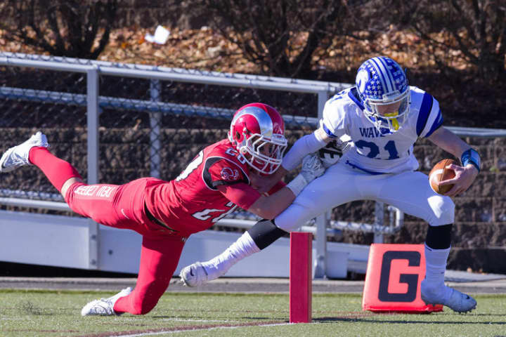 Darien&#x27;s Nick Lombardo pulls in a pass near the goal line against New Canaan during their game on Thanksgiving. The teams meet again on Saturday in Stamford for the Class L championship.