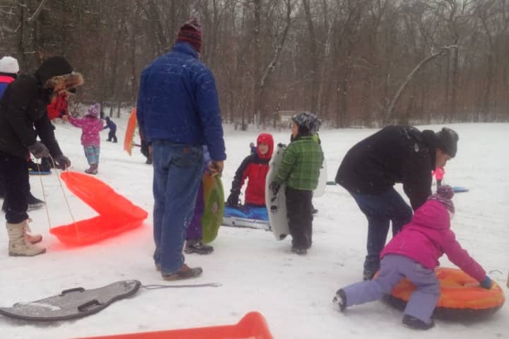 Kids and adults enjoy sledding in Darien&#x27;s Baker Park Saturday afternoon.