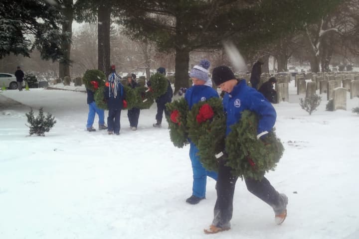 Volunteers participate in national Wreaths Across America Day in Darien on Saturday.