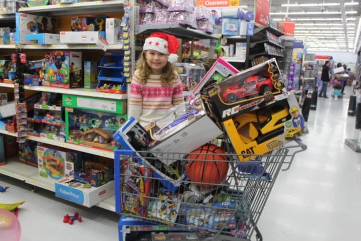 Children of the Sound clinic swimmer Alexis Robinson, 5, of Westport, takes a break from swimming laps to support the toy drive that will benefit Al&#x27;s Angels. 