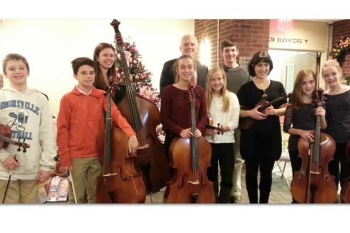 Lawrence Hospital Center President and CEO Edward M. Dinan greets members of the Bronxville Middle School orchestra and its director,  Claire Stancarone.