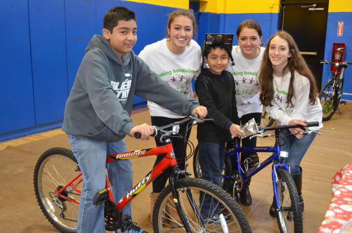 Rye&#x27;s Linking Handlebars recently donated 60 bicycles and helmets to children at the Don Bosco Center in Port Chester. 