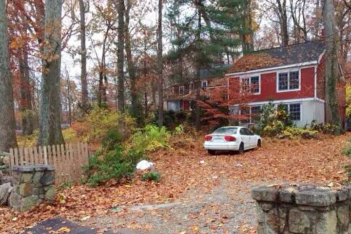The home at 77 Range Road in Wilton was the site of a vicious dog attack in which the homeowner lost one of her arms and part of the other.