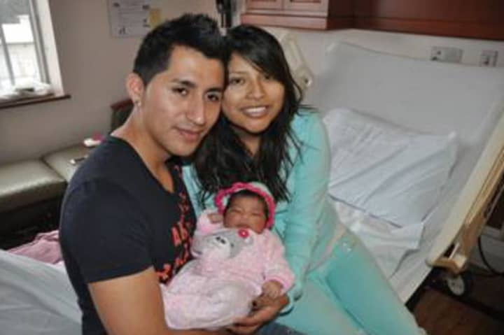 Alex Quiroga (left) and Marcela Ona (right) of Peekskill hold their first born, baby Ayleen.