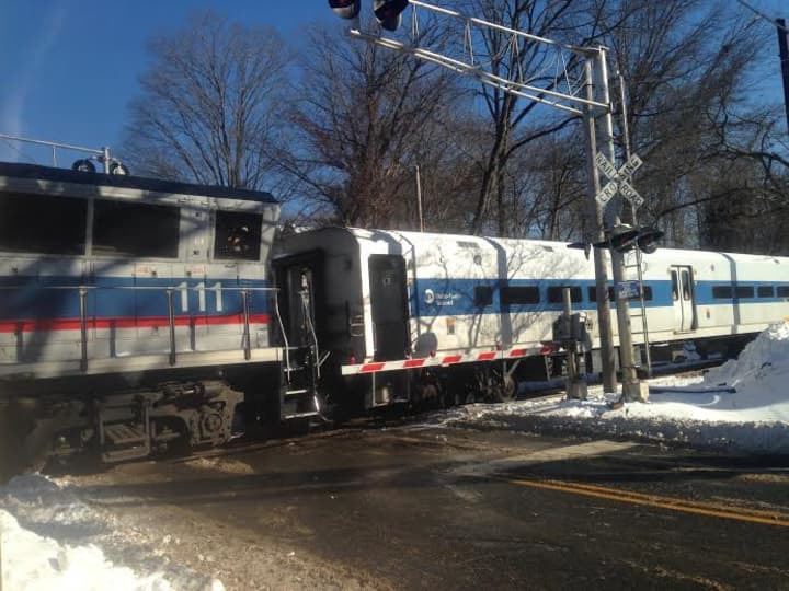 A Metro-North train sits at the crossing at Shelter Rock Road on Saturday afternoon after striking a car. 