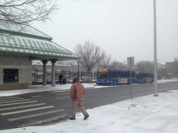 It&#x27;s cold and a light snow is falling at the bus stop in downtown Danbury on Tuesday afternoon. 