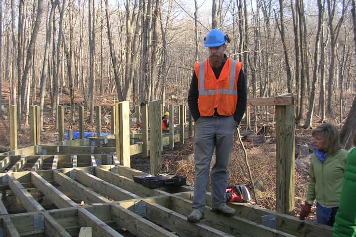 Josh Ryan monitors construction of a boardwalk as part of the Norwalk River Valley Trail.