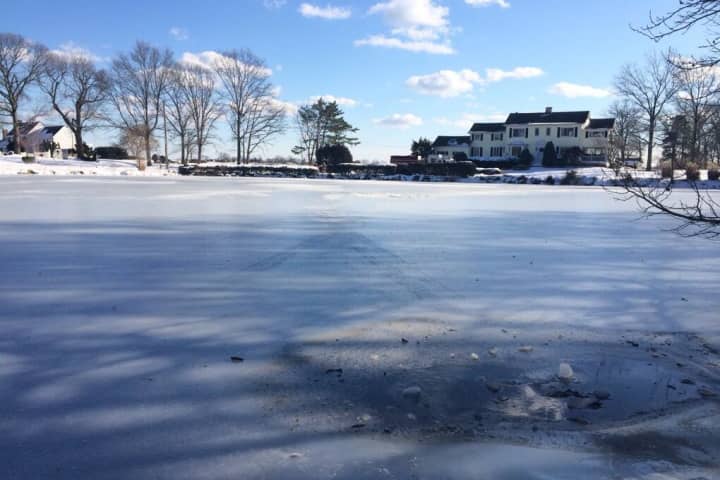 Two teenage boys are safe after being pulled from this icy pond in Greenwich.
