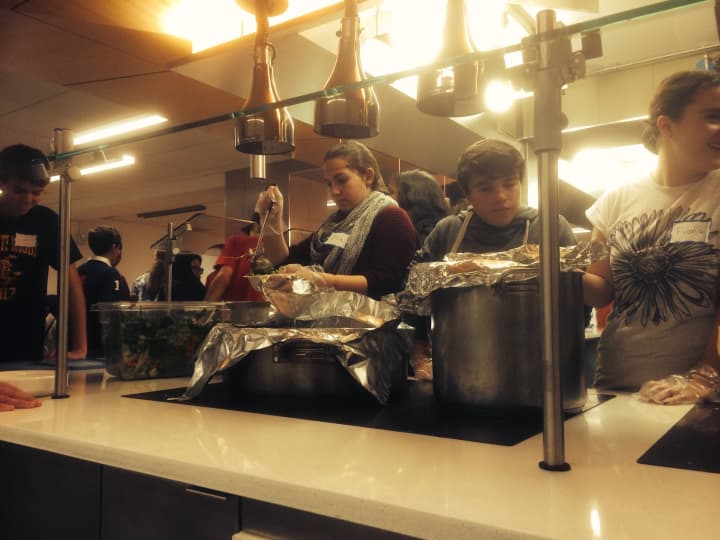 Liam Tobin works with his classmates to serve dinner to the homeless in New York City.