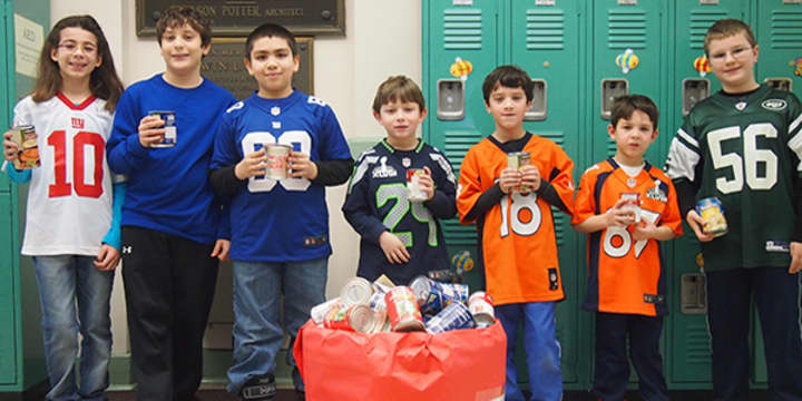Parsons Elementary School students are shown with cans collected in &quot;Souper Bowl.&quot; 