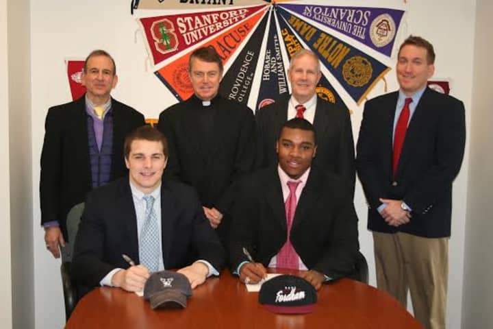 Fairfield Prep football players Nick Crowle, (front, left) and Tony Fox sign to play for college programs. Back row are Dr. Robert Perrotta, Principal; Rev. John Hanwell, S.J., President; Tom Shea, coach ; Keith Hellstern, assistant coach.