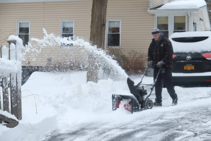 Bob McCann clears his driveway Wednesday morning. 