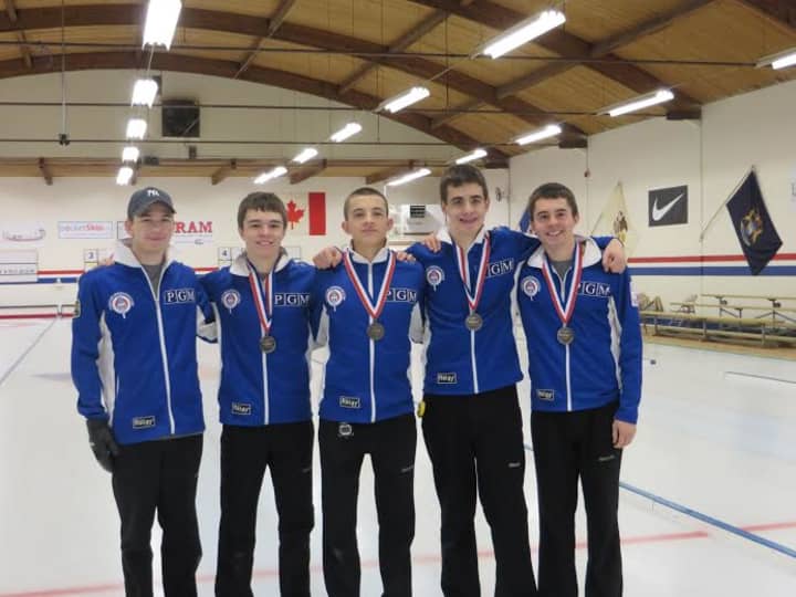 Tean Dunnam, with Briarcliff resident Andrew Stopera (second from right), celebrates their second place finish at curling nationals in Seattle.