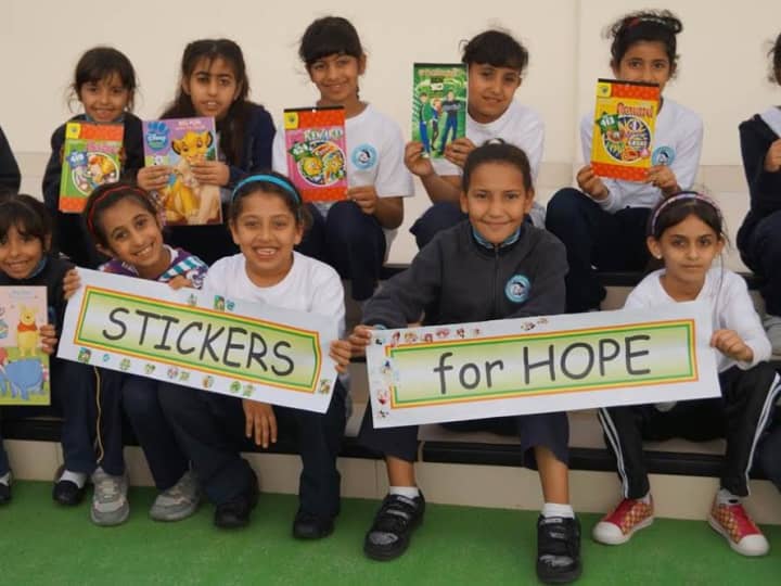 Students in Abu Dhabi with their donations for &quot;Stickers for Hope.&quot; 
