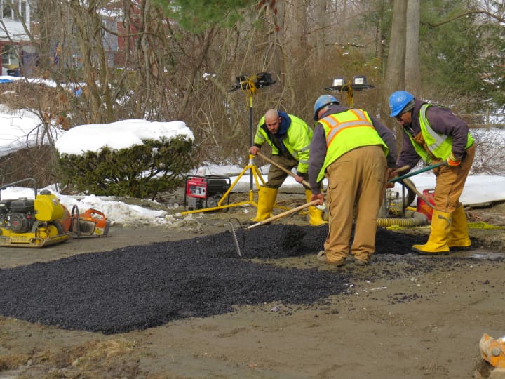 Crews work Sunday in New Rochelle to repair the road.