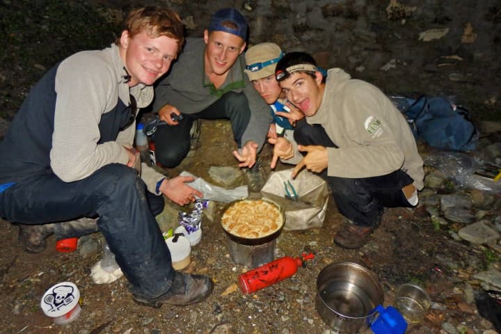 Andrew Allison-Godfrey, right, of Westport and fellow hikers cook during their excursion in India.