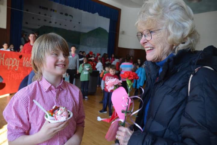 Rebecca Breed, right, shares a laugh with a boy at a previous Valentine&#x27;s Day ice cream party at the Boys &amp; Girls Club of Greenwich. 
