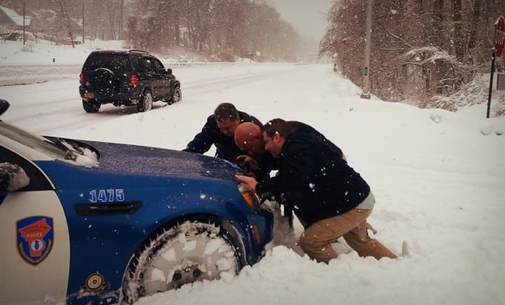 Yonkers Mayor Mike Spano gives officers a helping hand when a county police car got stuck in the snow.