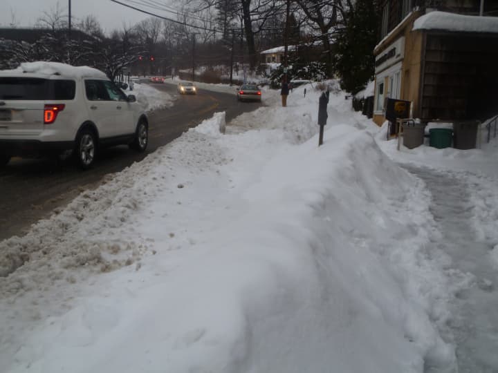 Piles of plowed snow narrow roadways in Westchester.