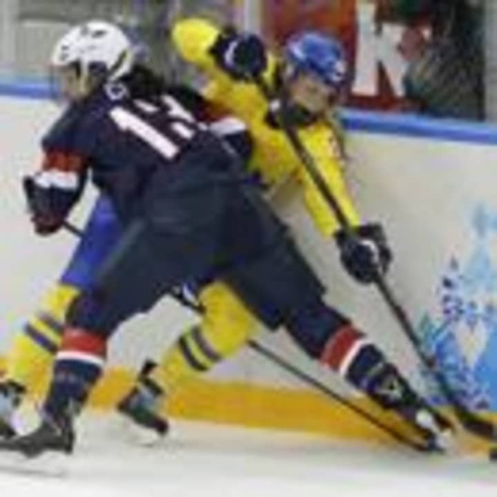 Julie Chu of the United States slams Michelle Lowenhielm of Sweden into the boards during the third period of Monday&#x27;s game. 