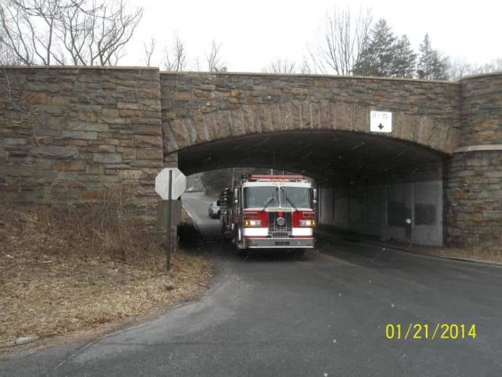 A photo taken by a consultant for Conifer Realty shows a Chappaqua fire truck driving under a bridge near 54 Hunts Place. 