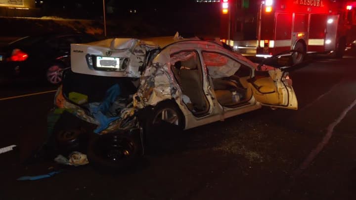 Firefighters had to extricate a woman from the backseat of this Acura after a four-vehicle pileup on I-95 in Norwalk. 