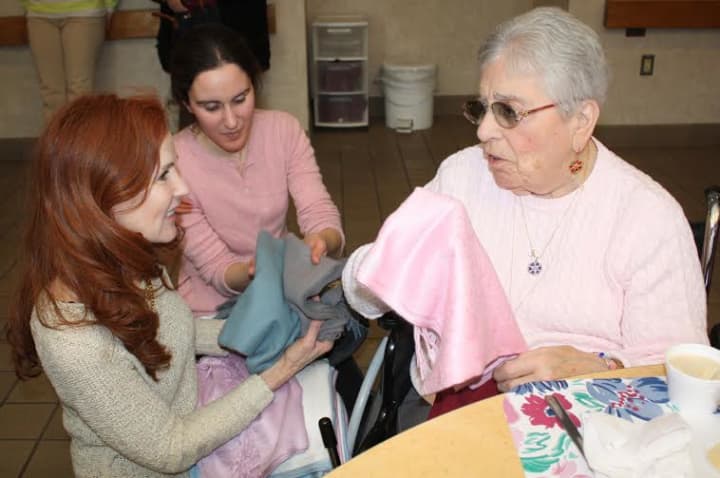 Employees from Caren Forbes &amp; Co.? of New Canaan donated scarves to the residents of Waveny Care Center recently. 