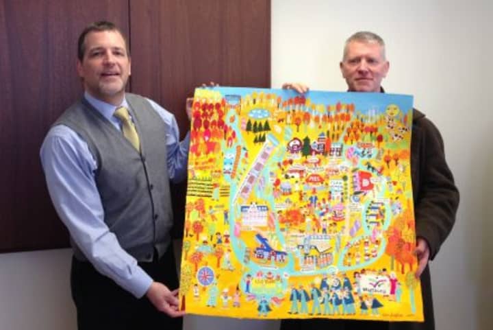 Wartburg President &amp; CEO David J. Gentner, left, and artist Christopher Corr unveil the Wartburg Fall Festival painting.