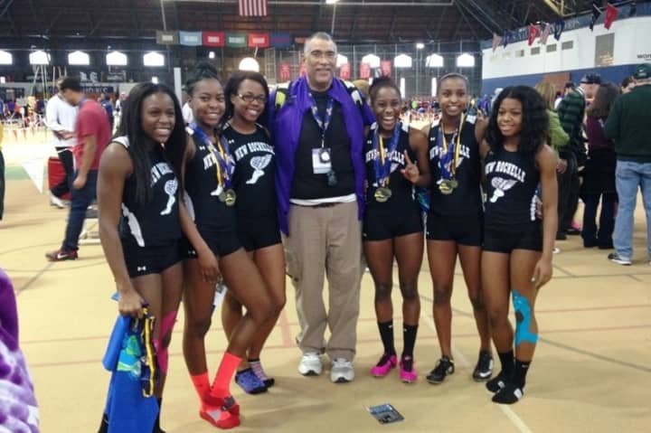 Members of New Rochelle&#x27;s 4 x 200 relay team celebrate their state championship.