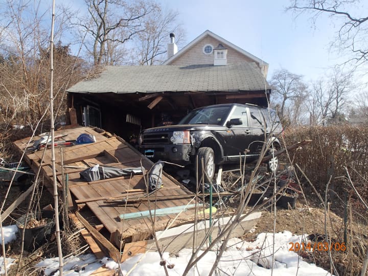 The garage of a home on Cunningham Place in Westport was heavily damaged Thursday morning after a Land Rover SUV drove through it. 