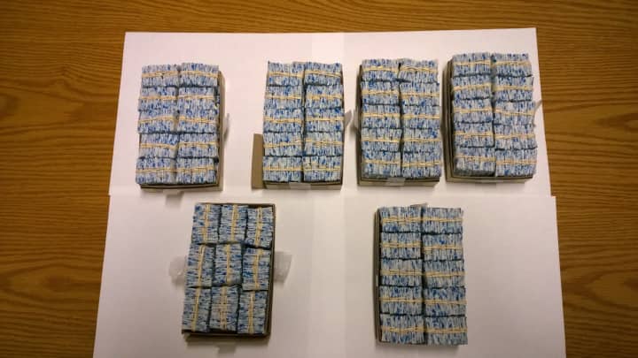Westchester Police discovered 5,900 bags of heroin in the car of a Conn. woman on Thursday.