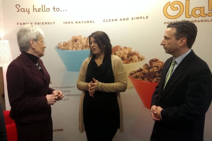 Ola! Foods founder Dina Houser (center) speaks with Lt. Gov. Nancy Wyman and State Sen. Bob Duff at her Norwalk business Friday.