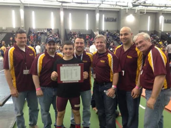 Norwalk Mad Bulls wrestler Jeff Cocchia, a state champion, gets congratulations from coaches (left to right) Randy Haus, David Slapin, Marco Hernandez, Art Schad, Jason Singer and Sam Ward.