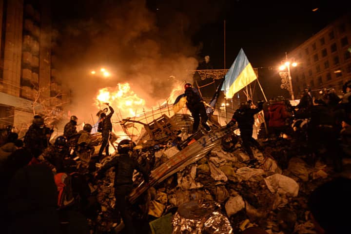 The state flag of Ukraine is carried by a protester to the heart of clashes in Kiev, Ukraine, on Feb. 18.
