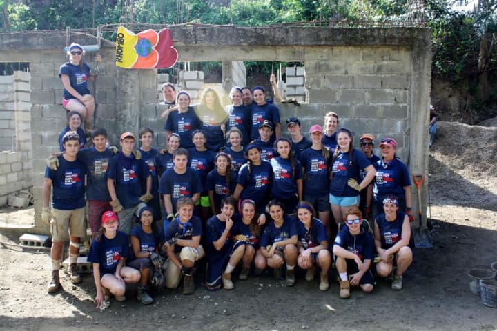 Students from the &quot;Rhombo&quot; Team pose in front of a health clinic they helped to erect. Students on this team represent schools in Fairfield and Westport.