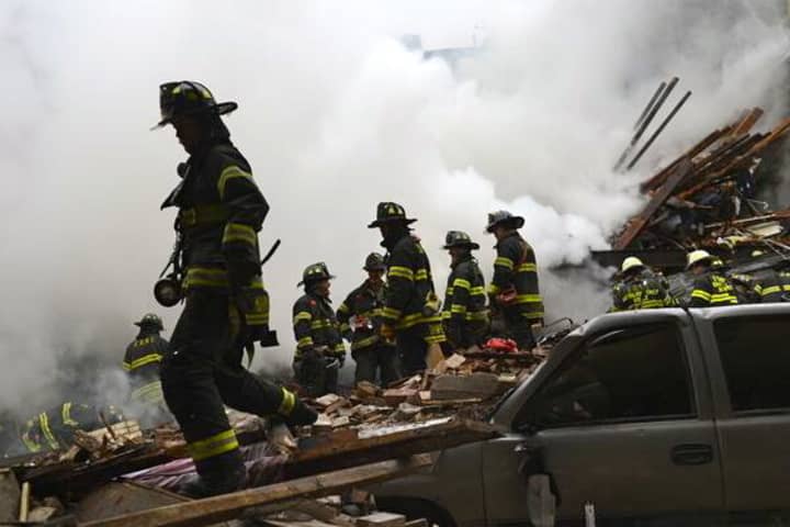 Fire crews survey the wreckage of a building in Harlem that was destroyed in an explosion on Wednesday.