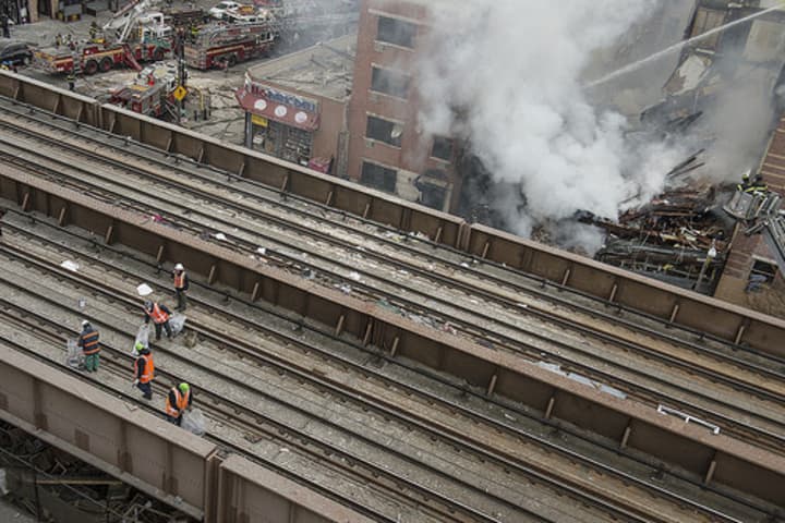 MTA crews clear tracks in Harlem Wednesday in order to resume Metro-North train service.