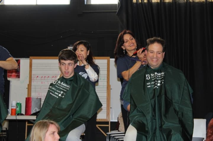 Dozens of people attend last year&#x27;s St. Baldrick&#x27;s head shaving event at Osborn Hill School to support families who have lost children in Fairfield. 