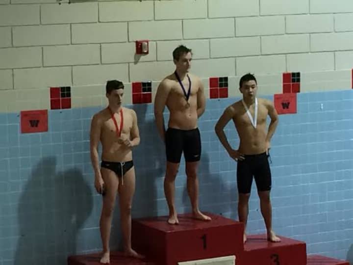 Wilton Wahoosswimmer Stephen Holmquist receives his gold medal after winning and setting a new pool record at Wesleyan University Pool in the 400 individual medley.